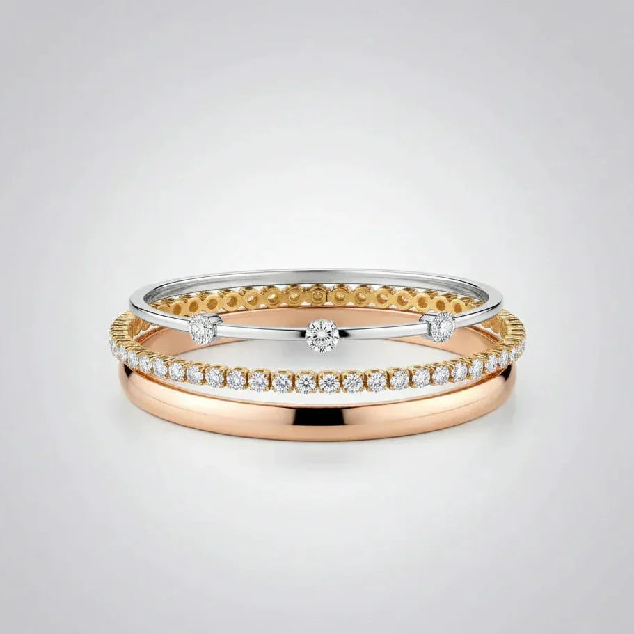 A sophisticated layered bracelet stack from the TM & Co. Jewels collection, featuring a combination of gold and diamond-accented designs.