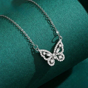 Silver butterfly necklace on a green fabric background-Butterfly Bliss Necklace - TM & CO. JEWELS 
