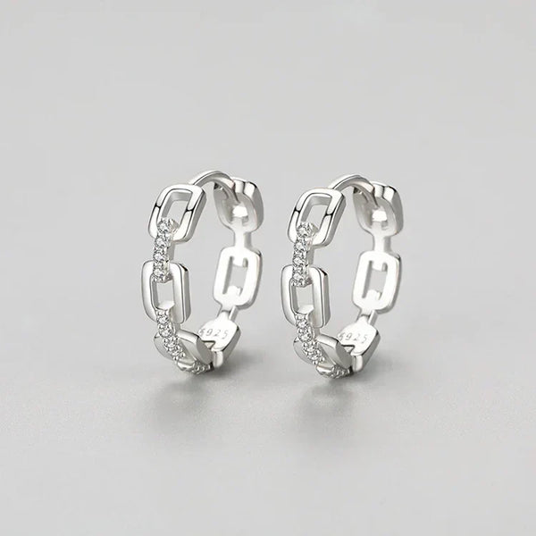 Pair of silver hoop earrings on a light gray background