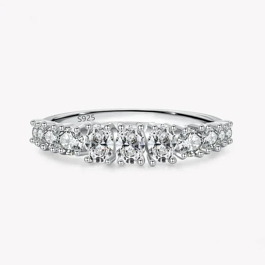 925 sterling silver ring with round white gemstones in a row on a plain background