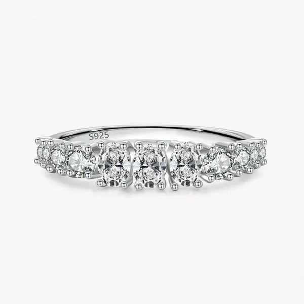 925 sterling silver ring with round white gemstones in a row on a plain background
