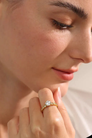 Close-up of a woman wearing a diamond ring on her finger.