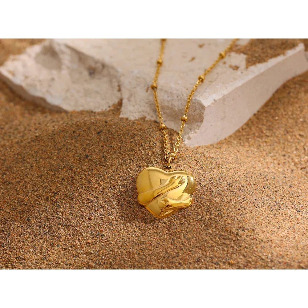 Gold heart-shaped pendant necklace on sand