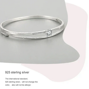 925 sterling silver bangle bracelet with central round cubic zirconia and delicate side stones