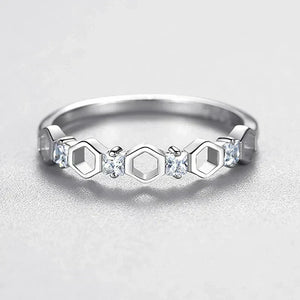 925 silver ring with hexagon shapes and small clear gemstones on a light background