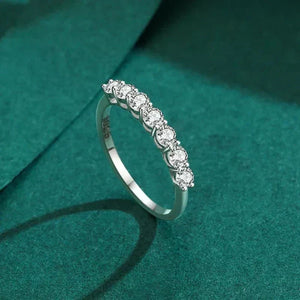 Silver ring with diamonds on a green textured background