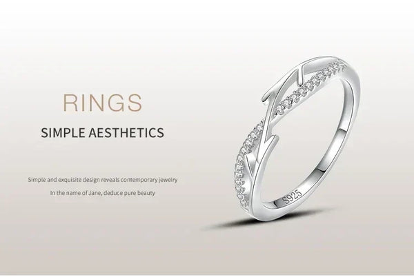 Sterling silver ring with leaf-inspired design and small clear stones, minimalist jewelry