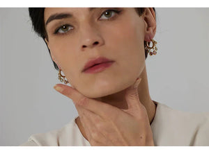 Woman wearing gold-plated drop earrings with crystals, elegant jewelry for women