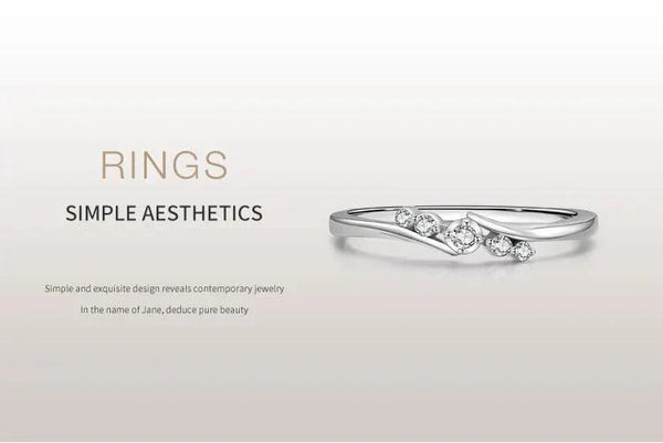 Minimalist silver ring with small sparkling gemstones on clean white background