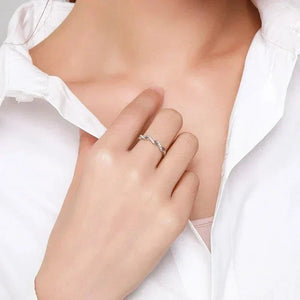 Hand wearing a twisted 925 silver ring, styled with a white collared shirt.