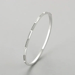 925 silver bangle bracelet with cubic zirconia accents on a white background