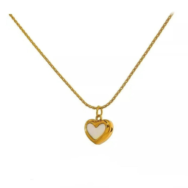 Gold necklace with a heart-shaped pendant on a white background