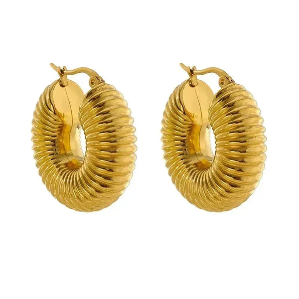 Gold-plated ribbed hoop earrings with a bold, textured design on white background.