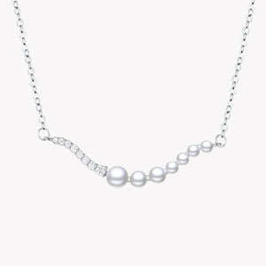 Silver necklace with graduated pearls and sparkling stones on a fine chain.
