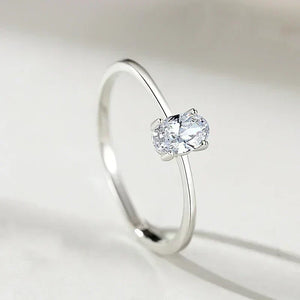 Minimalist 925 silver ring with oval-cut clear gemstone solitaire on white background