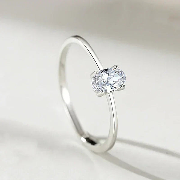 Minimalist 925 silver ring with oval-cut clear gemstone solitaire on white background