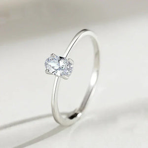 Minimalist 925 silver ring with oval-cut clear gemstone solitaire on white background