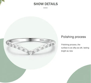 Silver ring with diamond accents on a white background