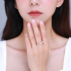 Woman wearing an elegant 925 silver ring with clear stones on her hand