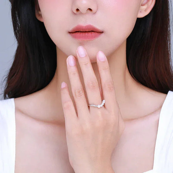 Woman wearing an elegant 925 silver ring with clear stones on her hand