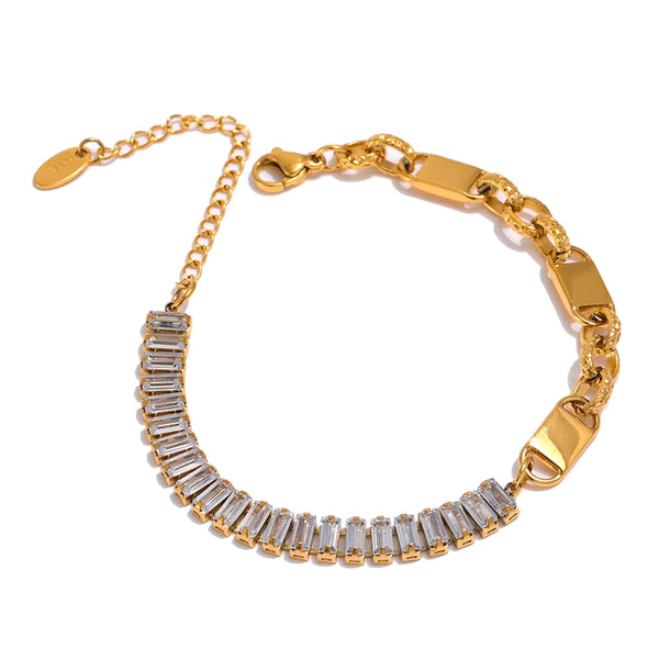Gold bracelet with clear gemstones on a white background