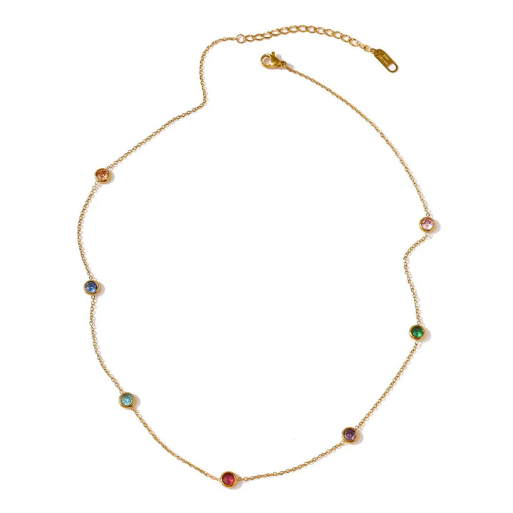 Gold necklace with colorful gemstones on a white background