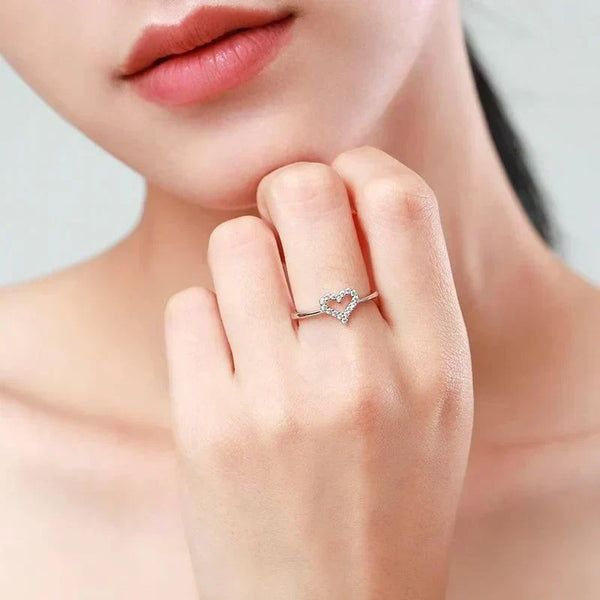 Woman wearing a delicate 925 silver heart-shaped ring with cubic zirconia accents