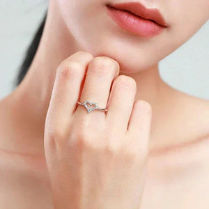 Woman wearing a delicate 925 silver heart-shaped ring with cubic zirconia accents