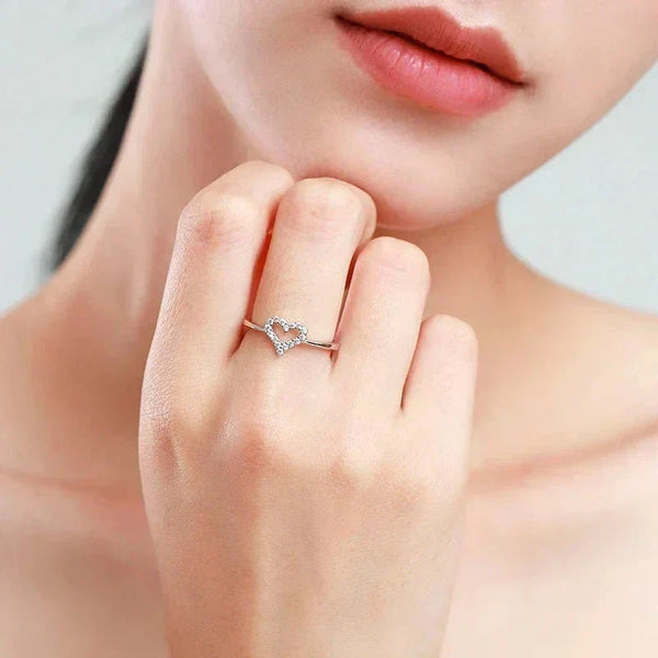Woman wearing a delicate 925 silver heart-shaped ring with cubic zirconia accents