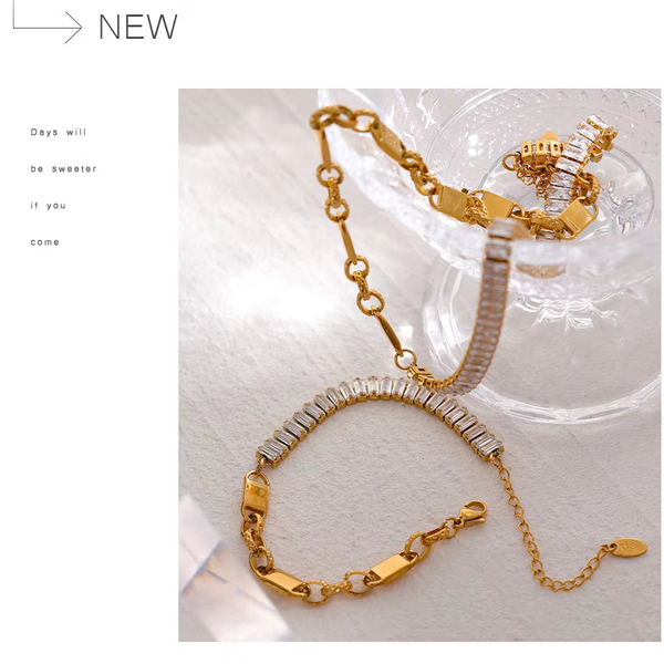 Gold-tone chain bracelet with silver-tone rectangular links, displayed on a clear glass dish against a white background with promotional text on the left.