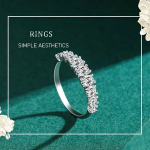 Silver ring with diamonds on a green background