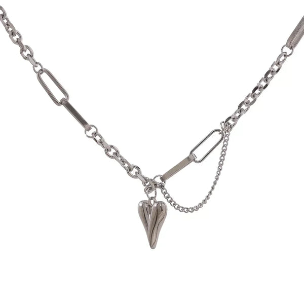 Sterling silver chain necklace with heart pendant and mixed link design on white background