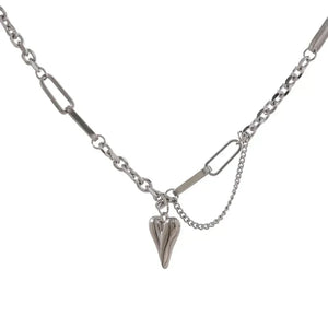 A silver-toned chain necklace featuring a central pendant with a textured shark tooth design, suspended from a multi-link chain with rectangular and oval connectors on a plain white background.