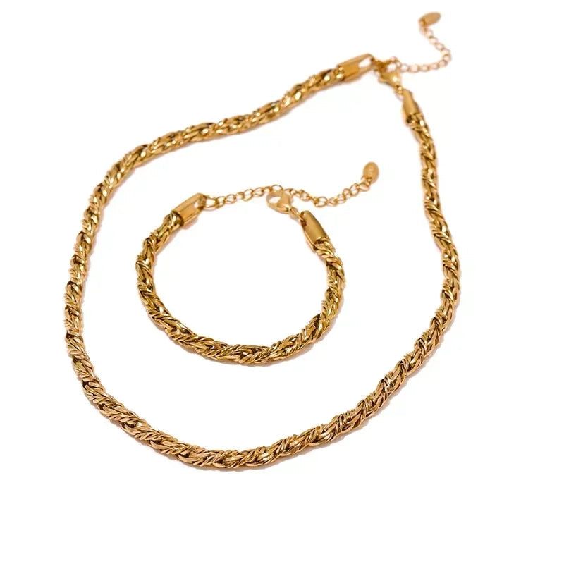 Gold chain necklace and bracelet set on a white background.