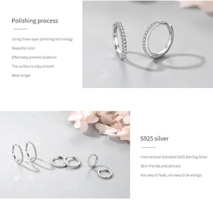 Silver rings with zirconia stones on a gray background, highlighting polishing process and material details.