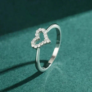 Silver ring with a heart-shaped diamond design on a teal background-TM & CO. JEWELS 