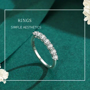 Silver ring with diamonds on a teal background with floral elements