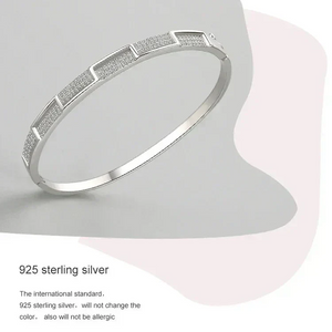 925 sterling silver geometric bangle bracelet with textured panels on neutral background