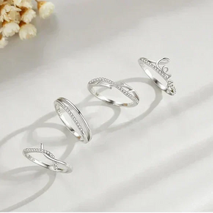  TM & CO. JEWELS  Set of silver rings with decorative elements on a soft fabric background.