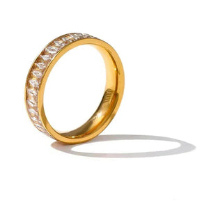 Gold ring with diamond accents on a white background