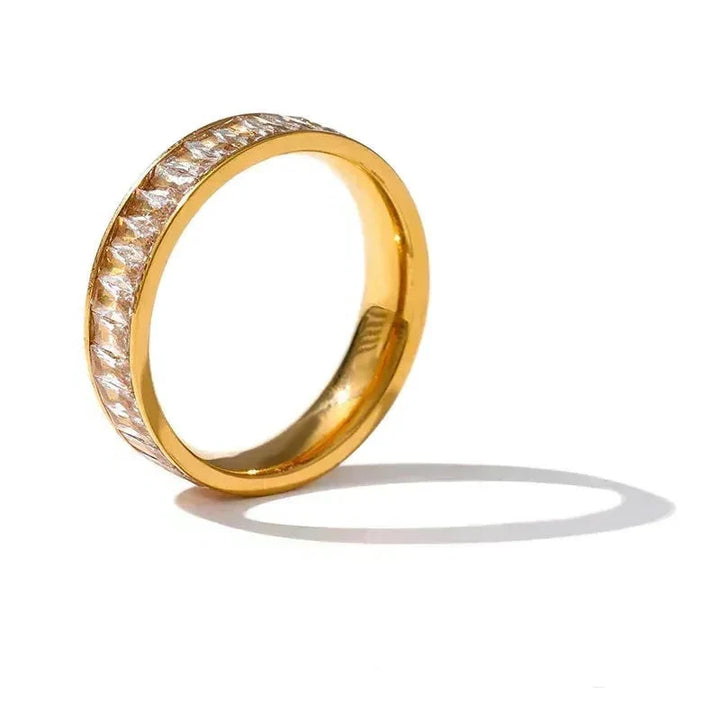 Gold ring with diamond accents on a white background