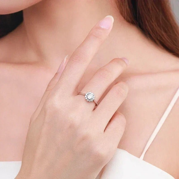 Woman wearing elegant silver floral cluster ring on finger, close-up, bridal jewelry
