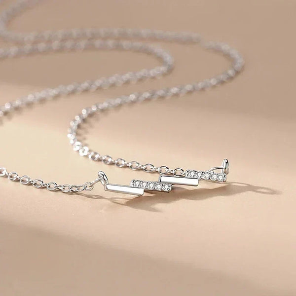 Silver necklace with a unique design on a beige background