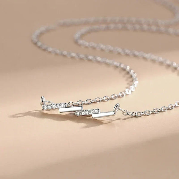 Silver necklace with a clasp on a beige background