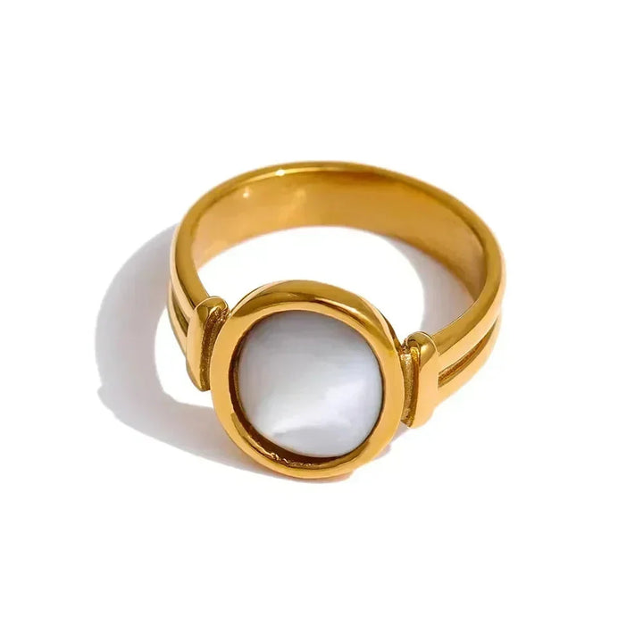 Gold ring with a white gemstone on a white background