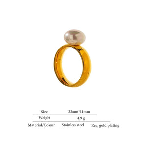 Gold-plated stainless steel ring with oval pearl accent on white background