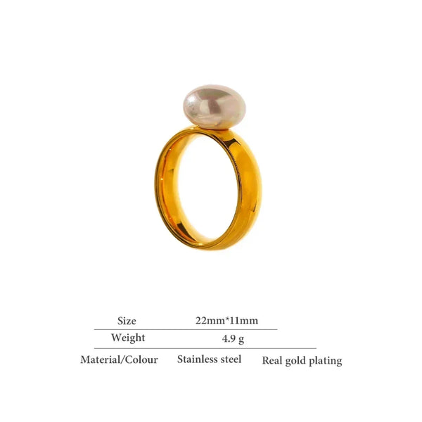 Gold-plated stainless steel ring with oval pearl accent on white background