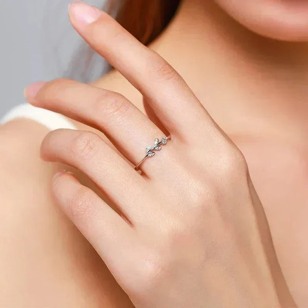 Delicate 925 silver leaf ring with cubic zirconia on woman's hand, minimalist jewelry