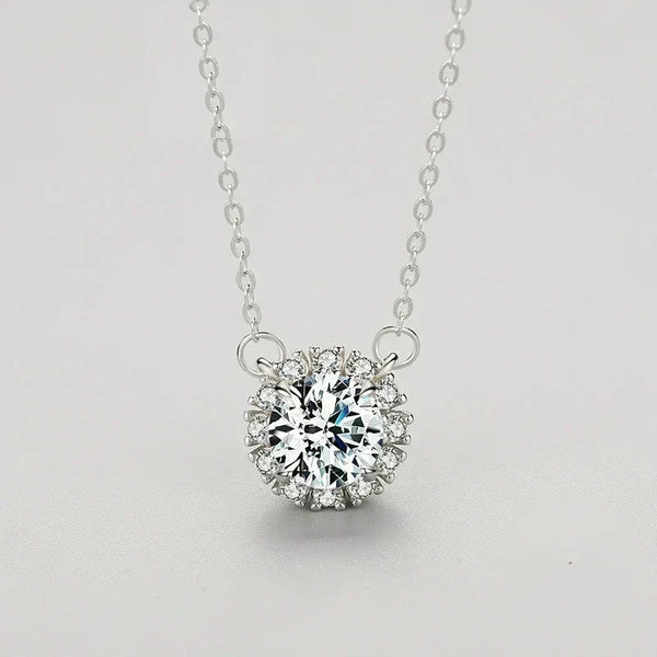 Silver necklace with a diamond pendant on a light gray background.
