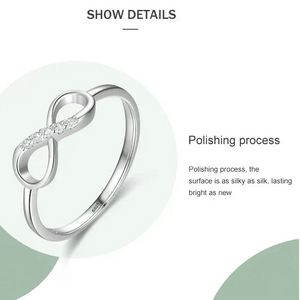 Silver infinity ring with polishing process text on a white background